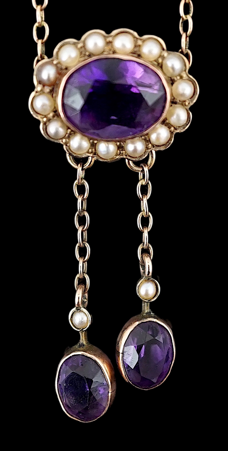 A cased Edwardian 9ct gold, amethyst and seed pearl cluster set double drop pendant necklace